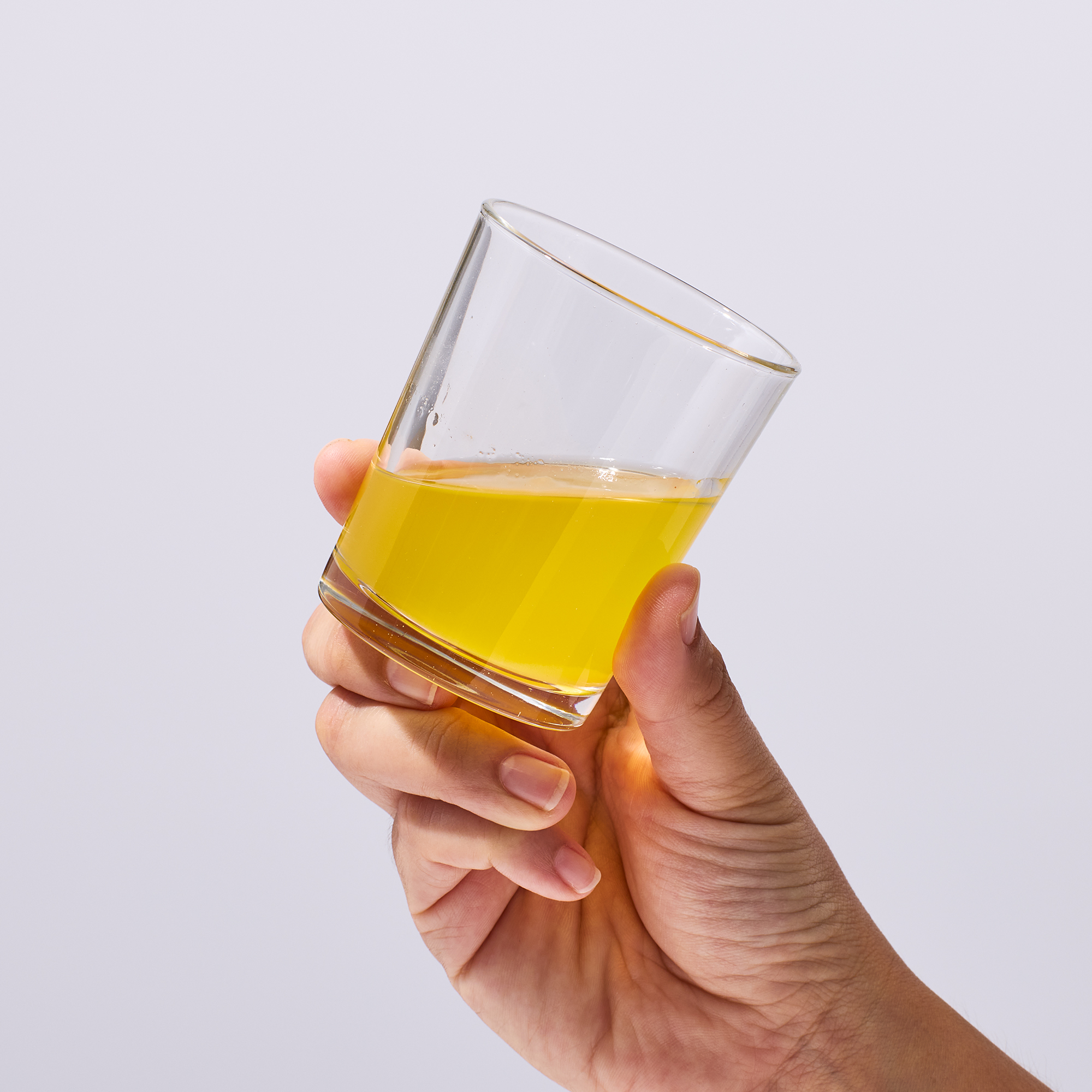 image of someone holding glass about to drink Isotonix Prime joint