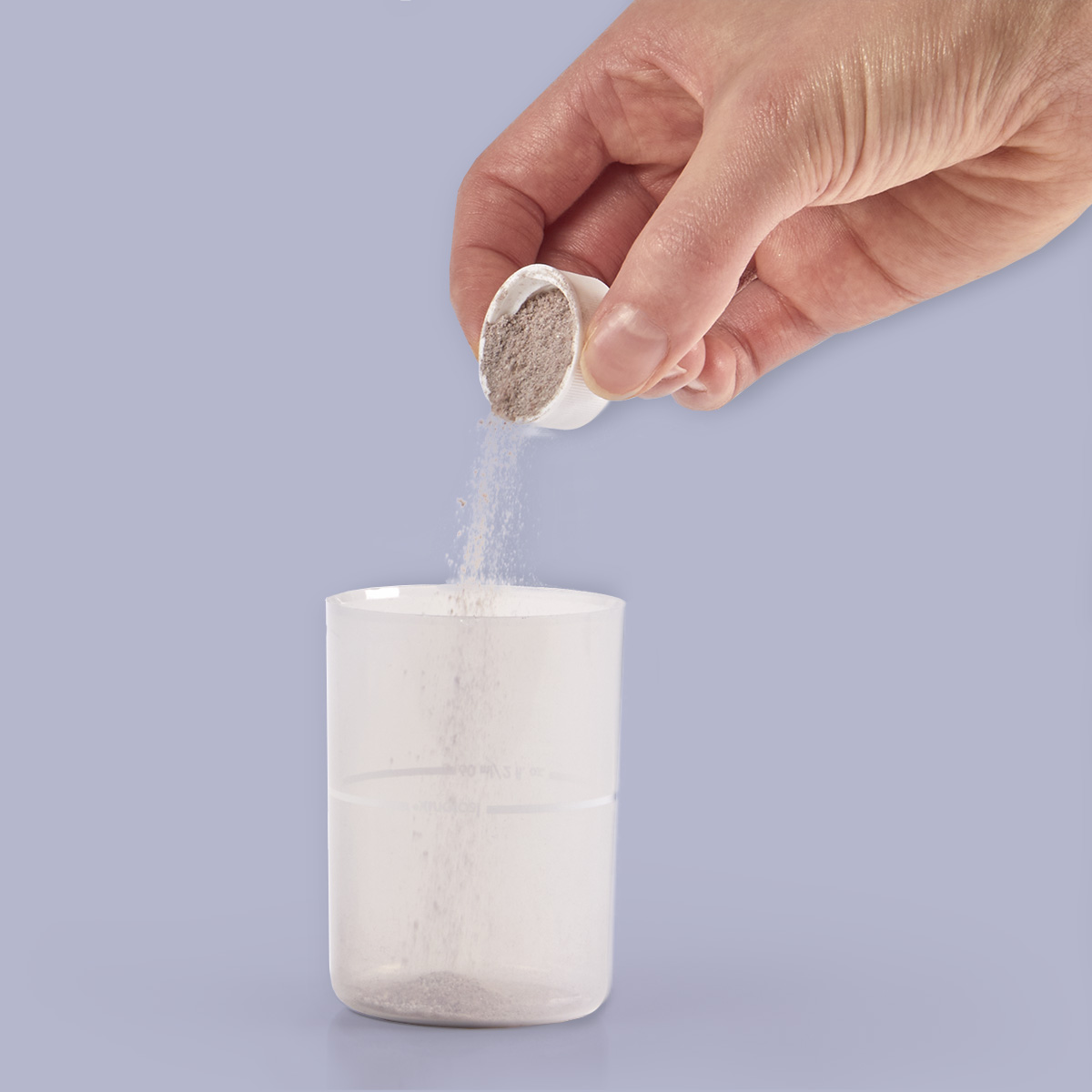 image of powder being poured in overcap