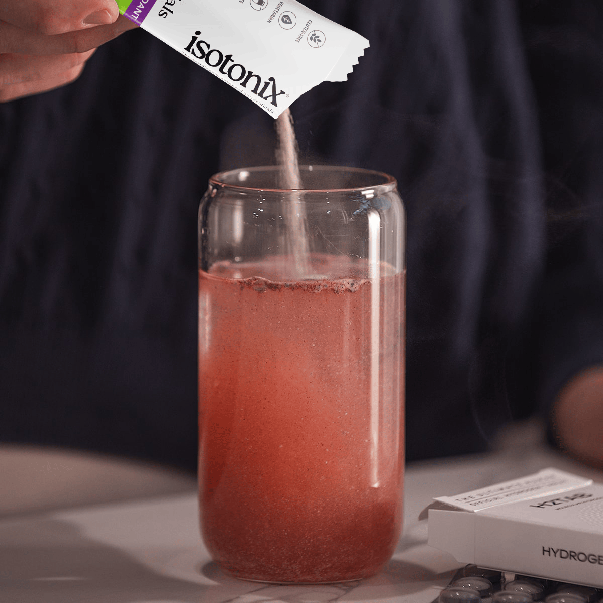 image of person pouring Isotonix Daily Essentials packet into water