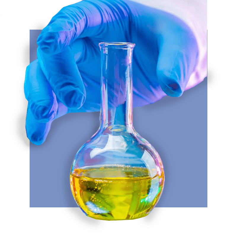image of hand holding beaker of oil