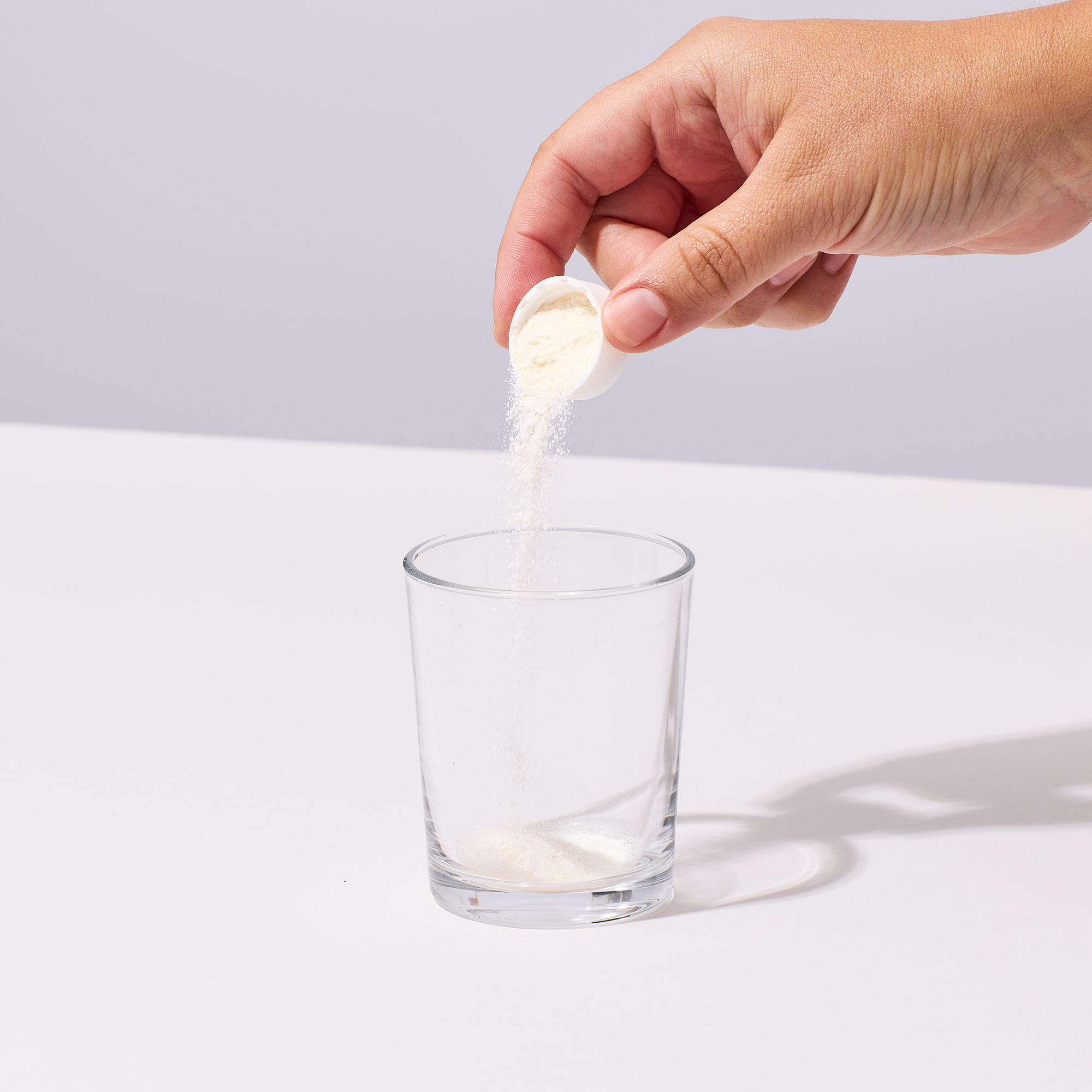 image of person pouring IX Magnesium into a glass