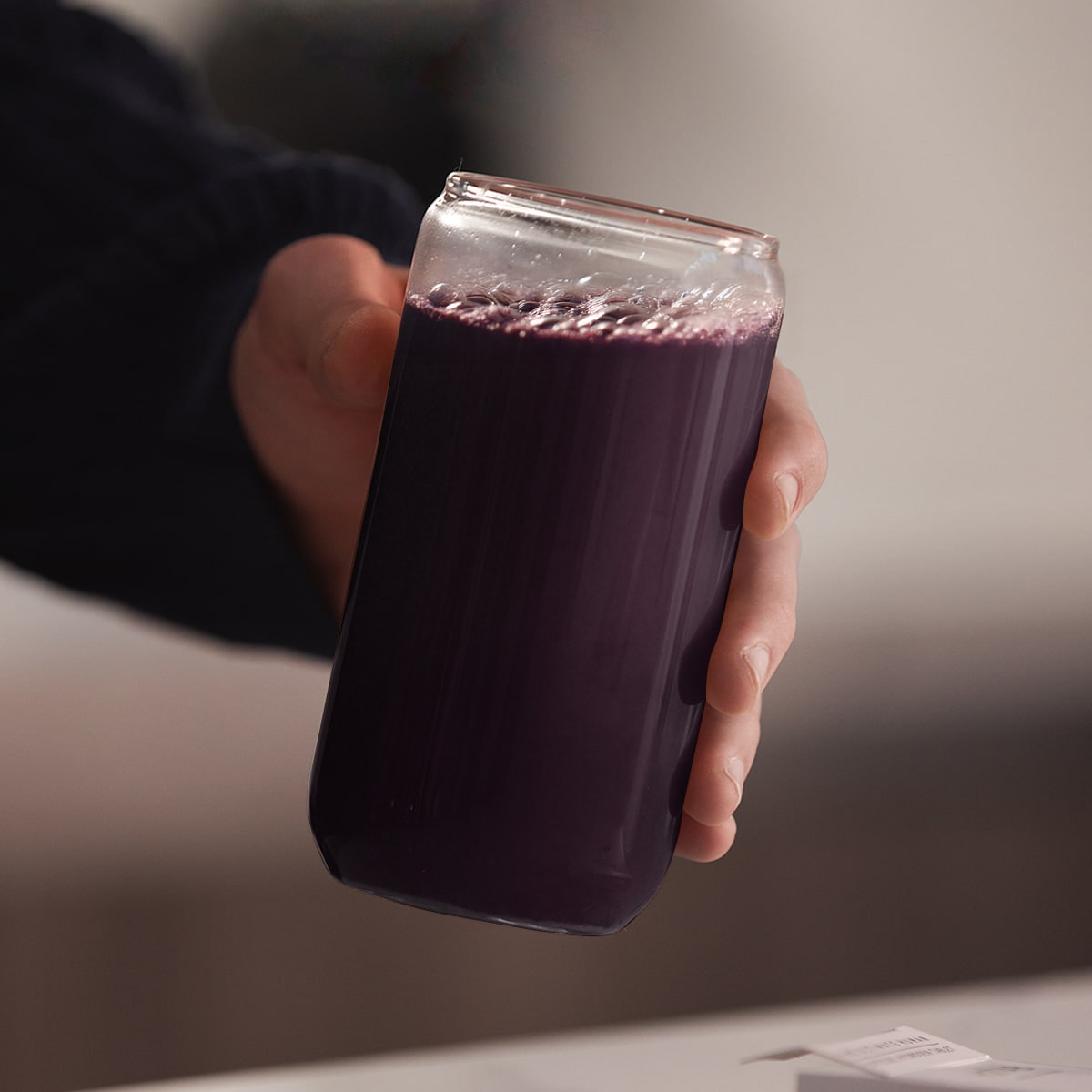 image of a person's handing lifting the glass to drink
