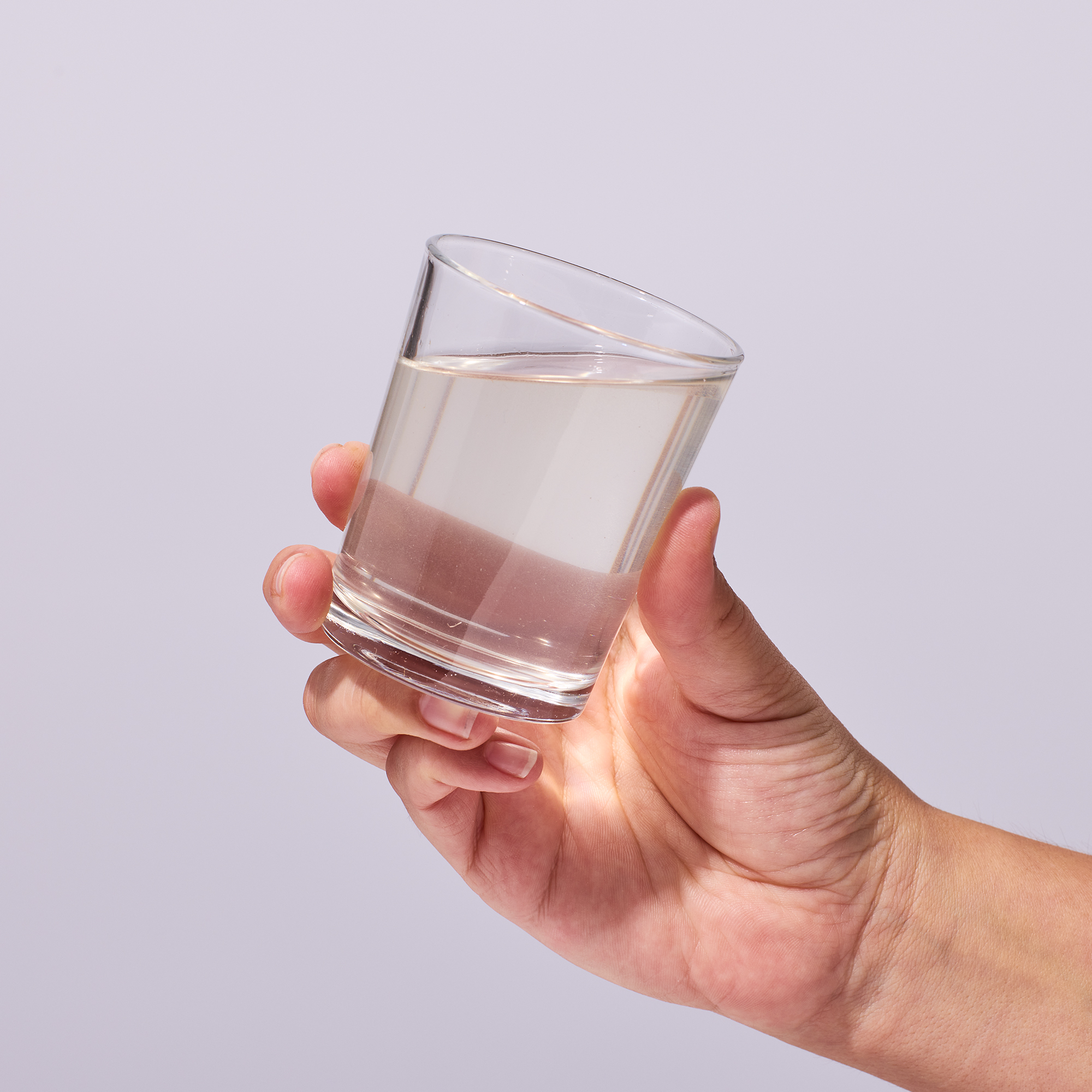 image of person lifting glass to drink