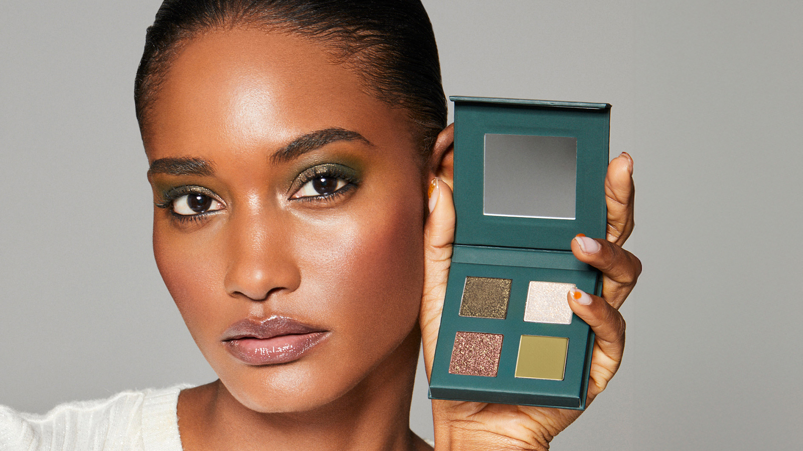 Woman holding the Enchanted palette next to her face