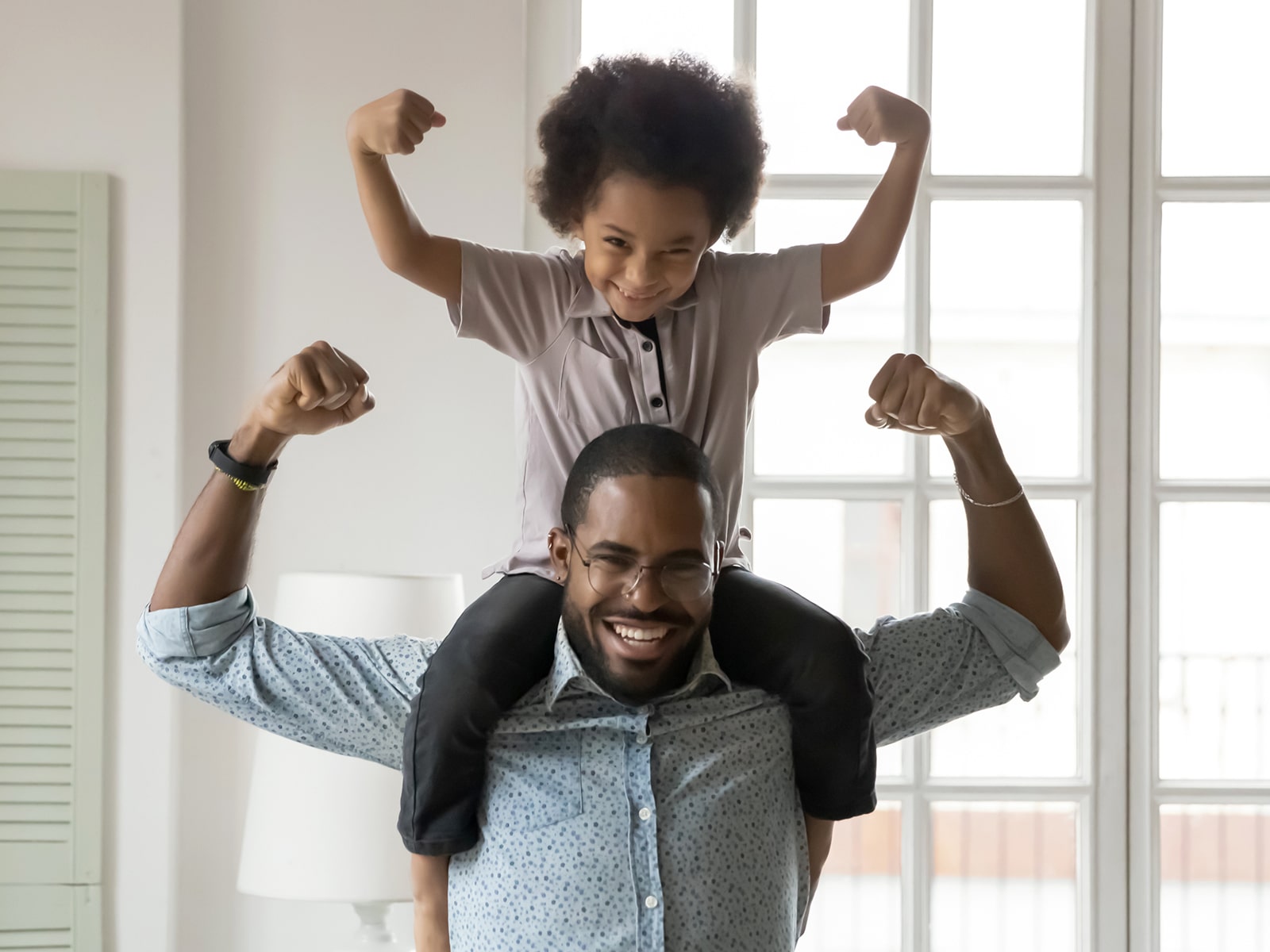 image of father and son flexing muscles