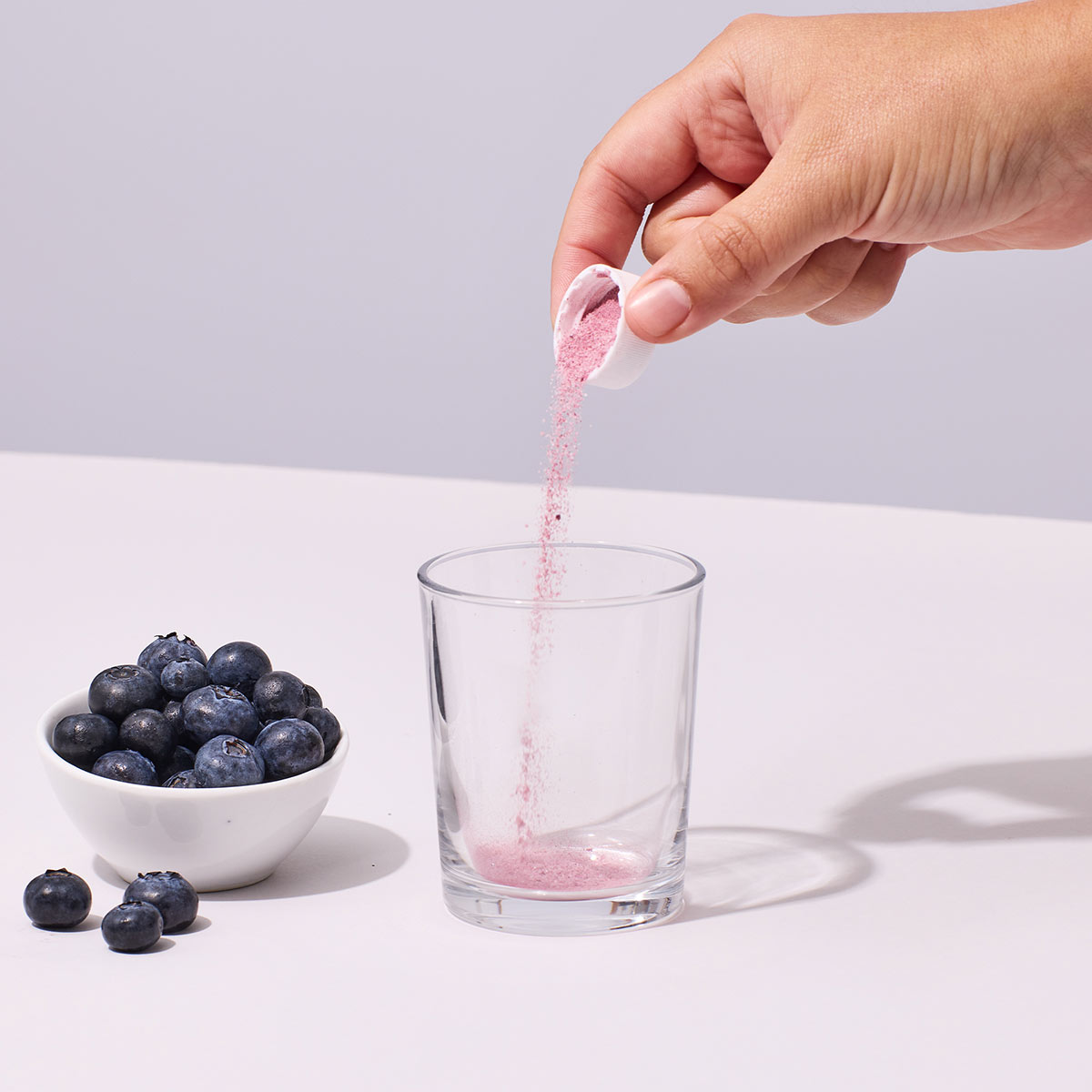 image of someone pouring one serving of Isotonix OPC-3 Beauty Blend into a glass