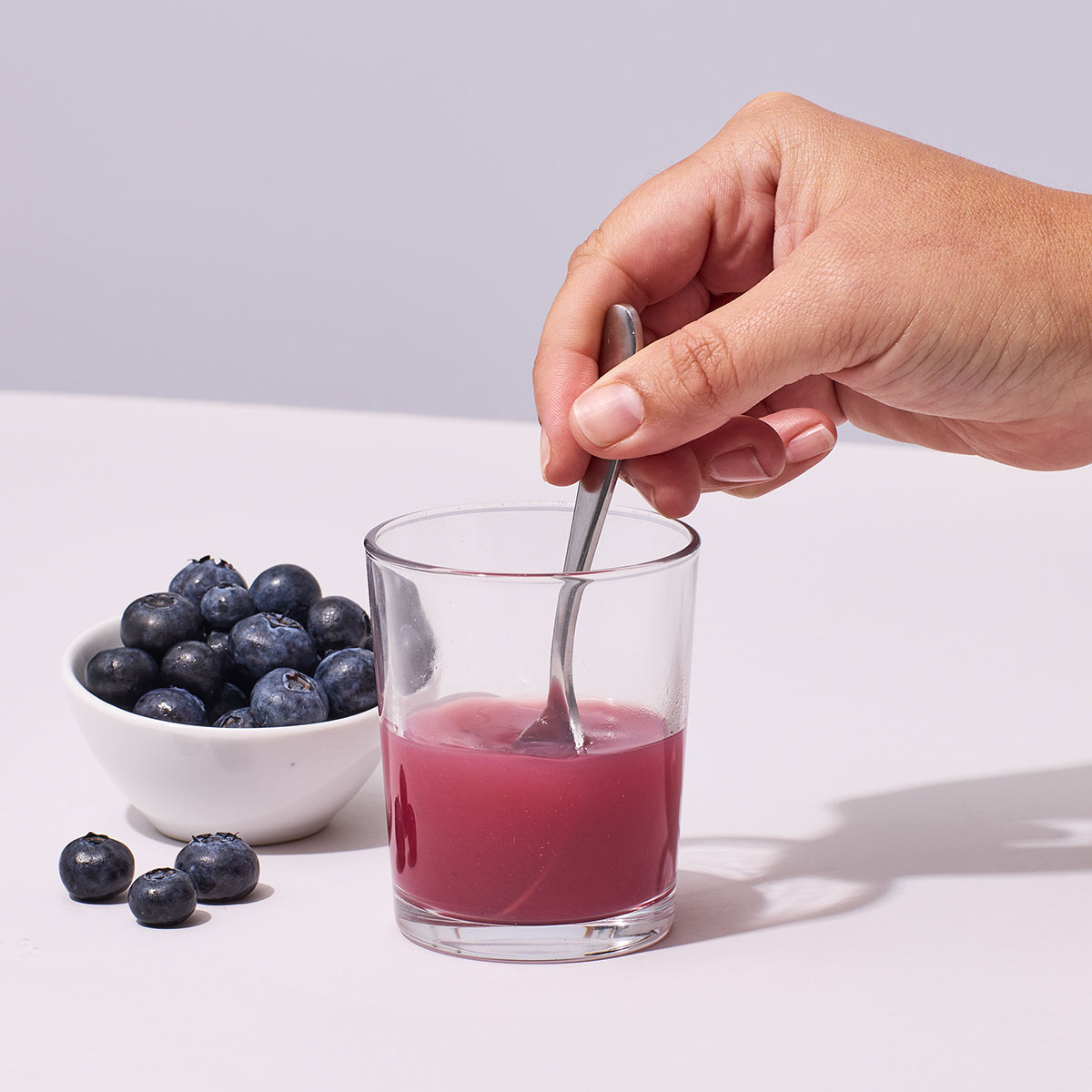 image of someone mixing up Isotonix OPC-3 Beauty Blend with water