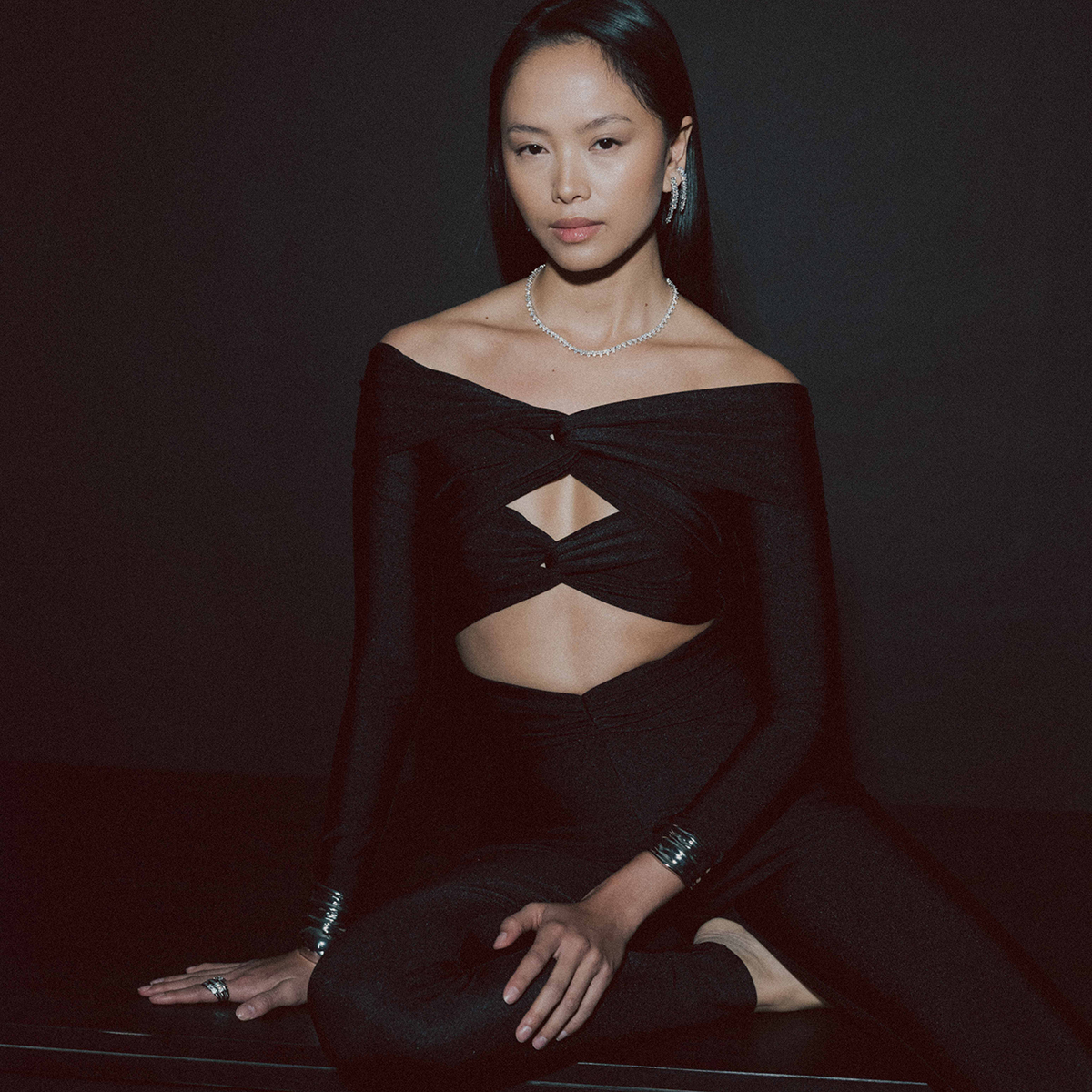 Model wearing layered jewelry