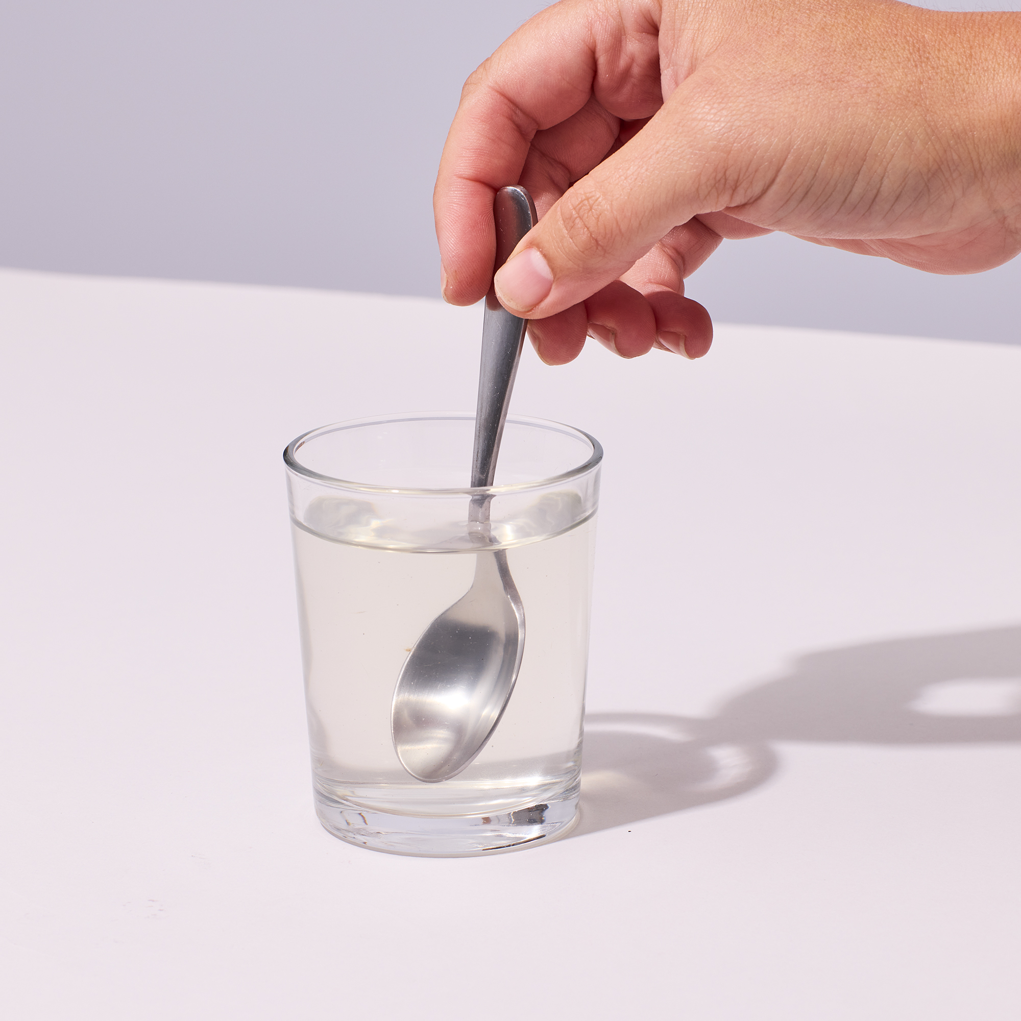 image of person stirring powder into water