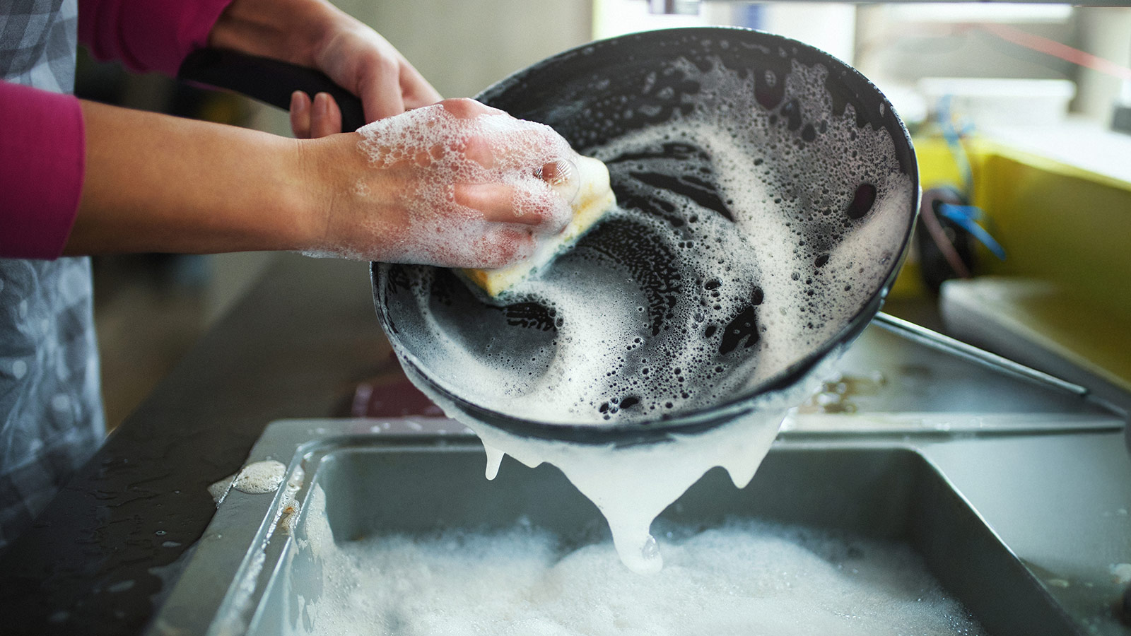 image of someone washing dishes