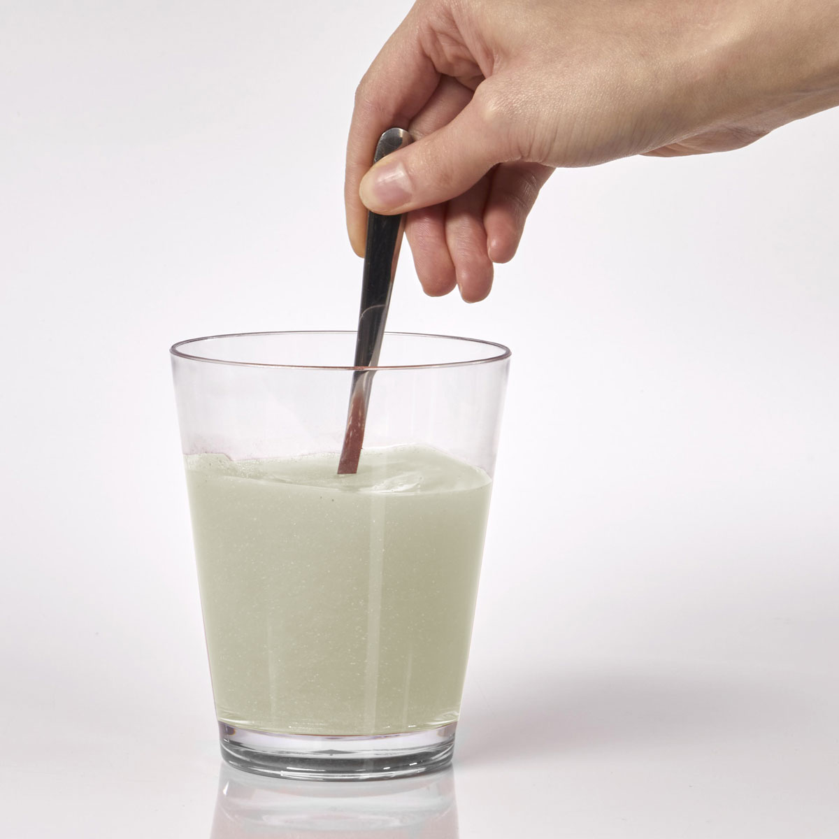 image of person stirring powder in water