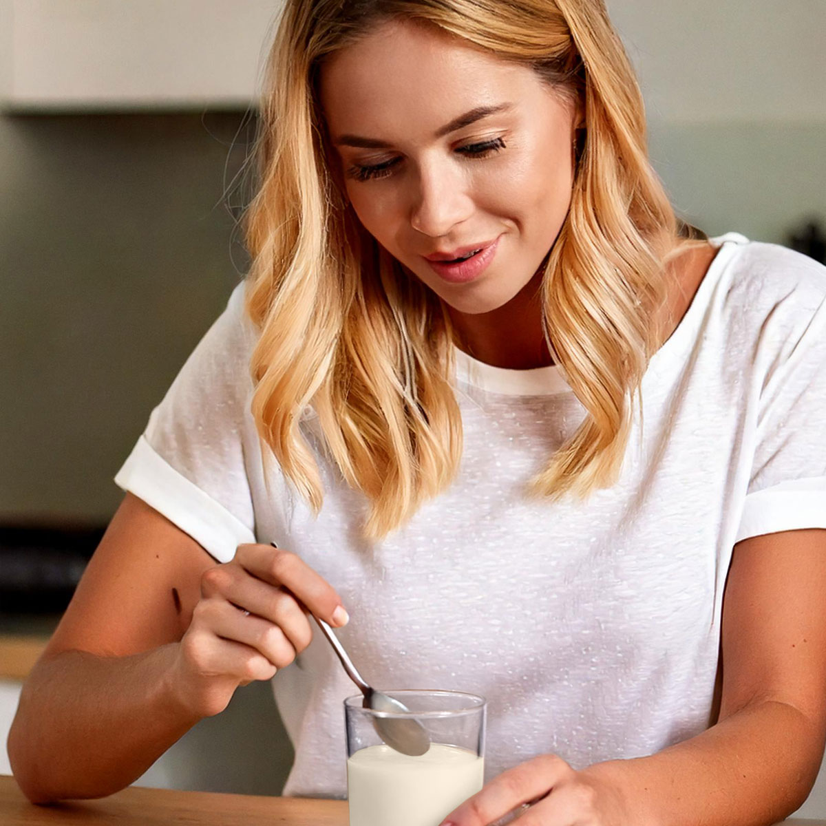 image of woman mixing colostrum powder and water