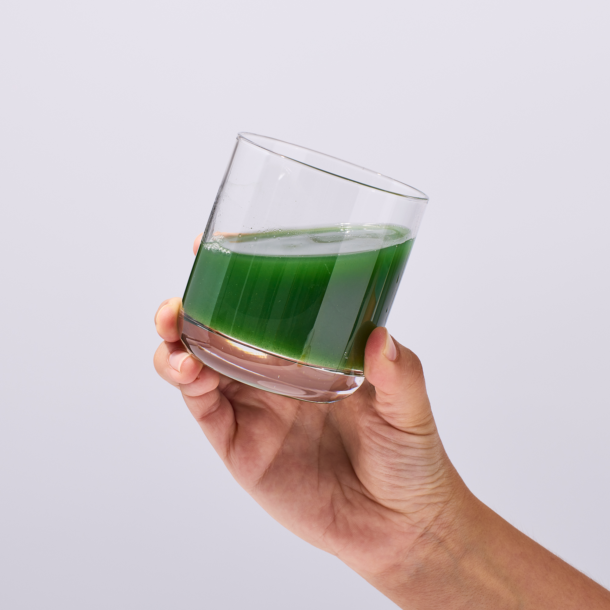 image of person holding cup about with a serving of IX Complete Greens