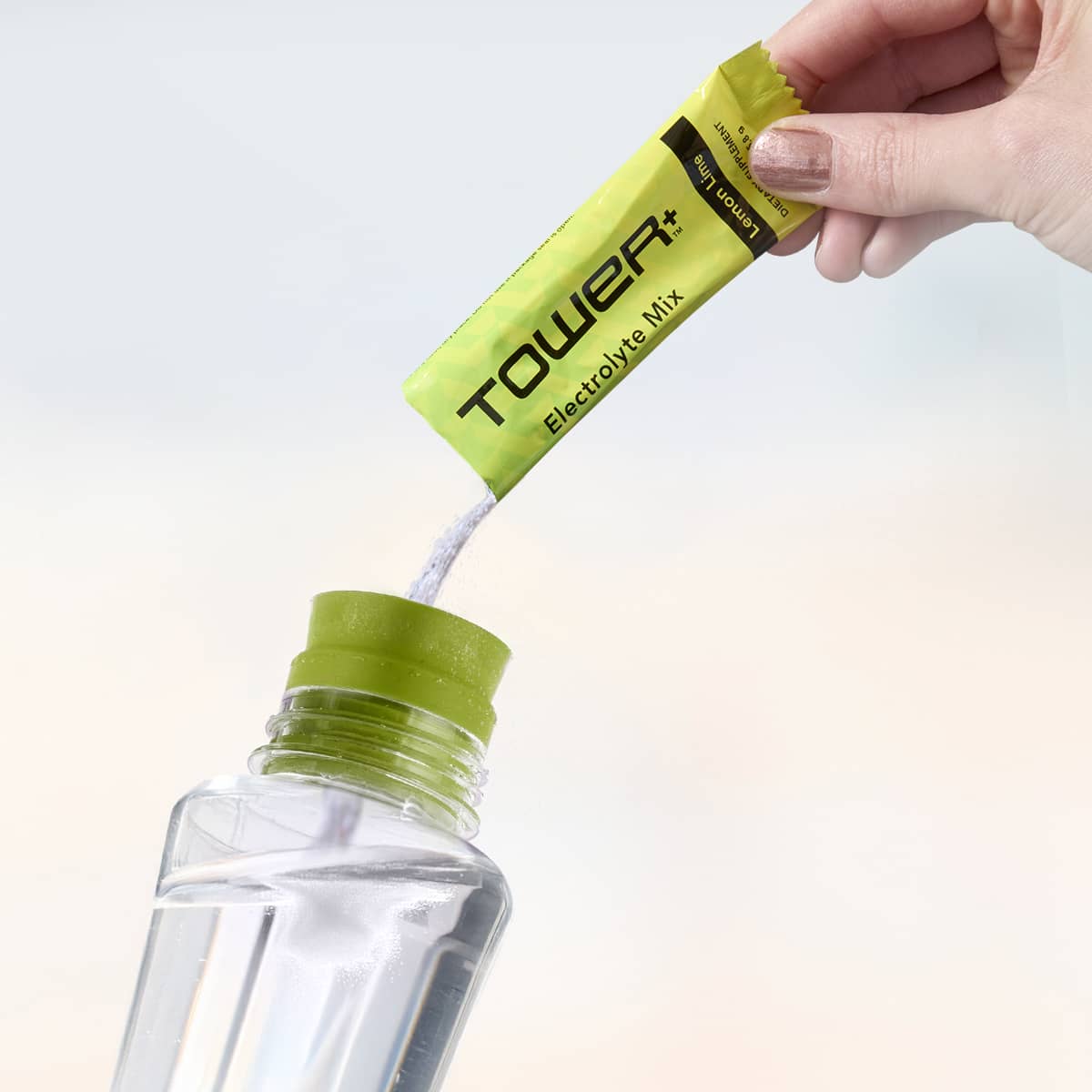 image of person pouring Tower+ Electrolyte Mix into a cup