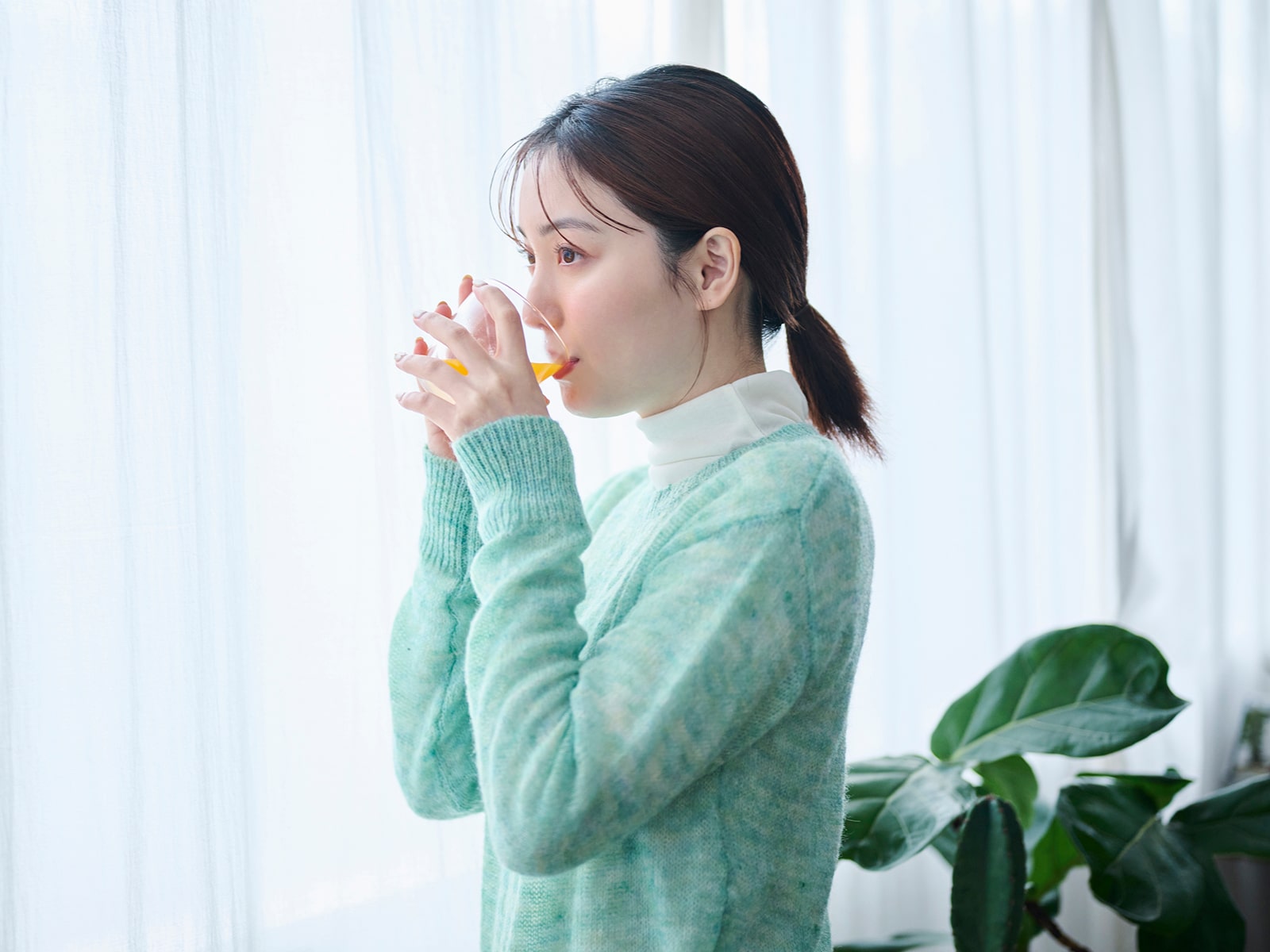 image of a woman drinking aloe juice