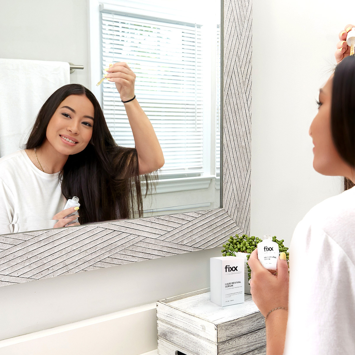 image of woman applying Fixx Hair Revival Serum to scalp
