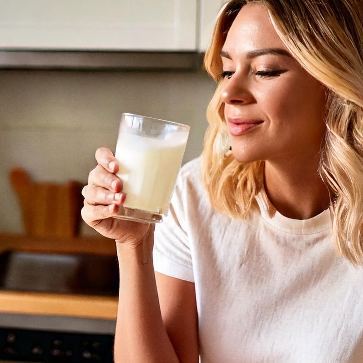 image of woman drinking colostrum