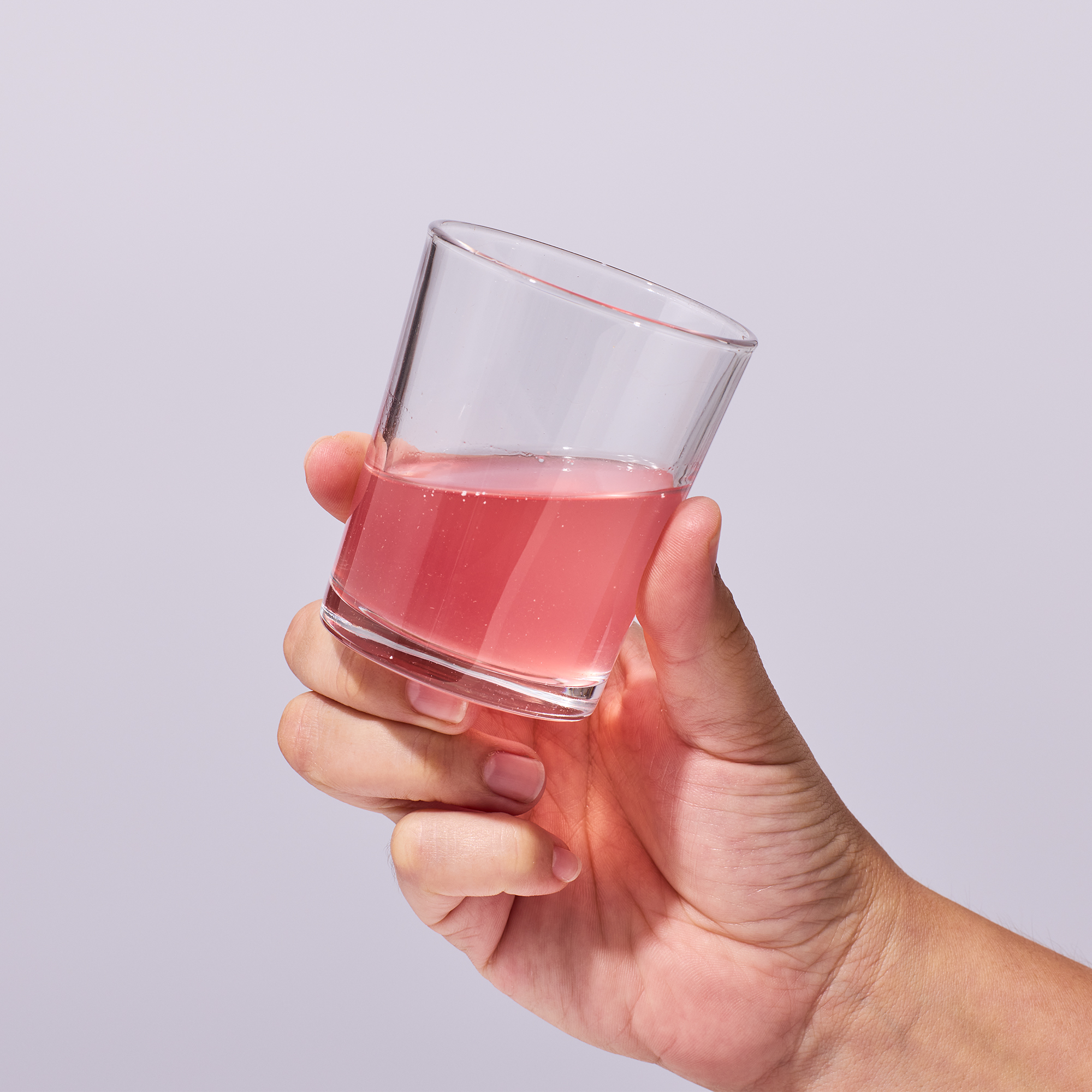 image of a woman drinking Isotonix Vitamin D with K2 from a cup