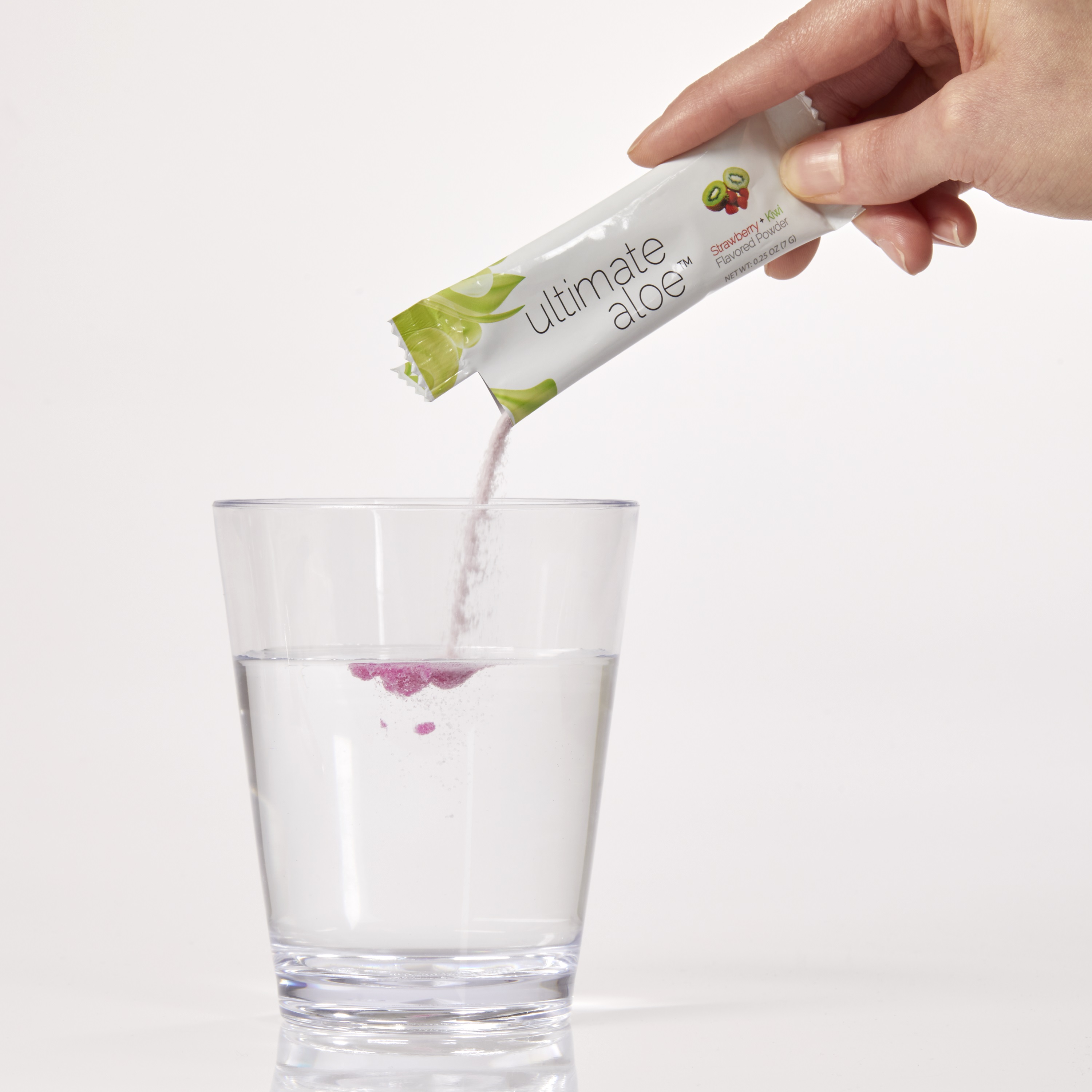 image of person pouring Ultimate Aloe powder in a cup.