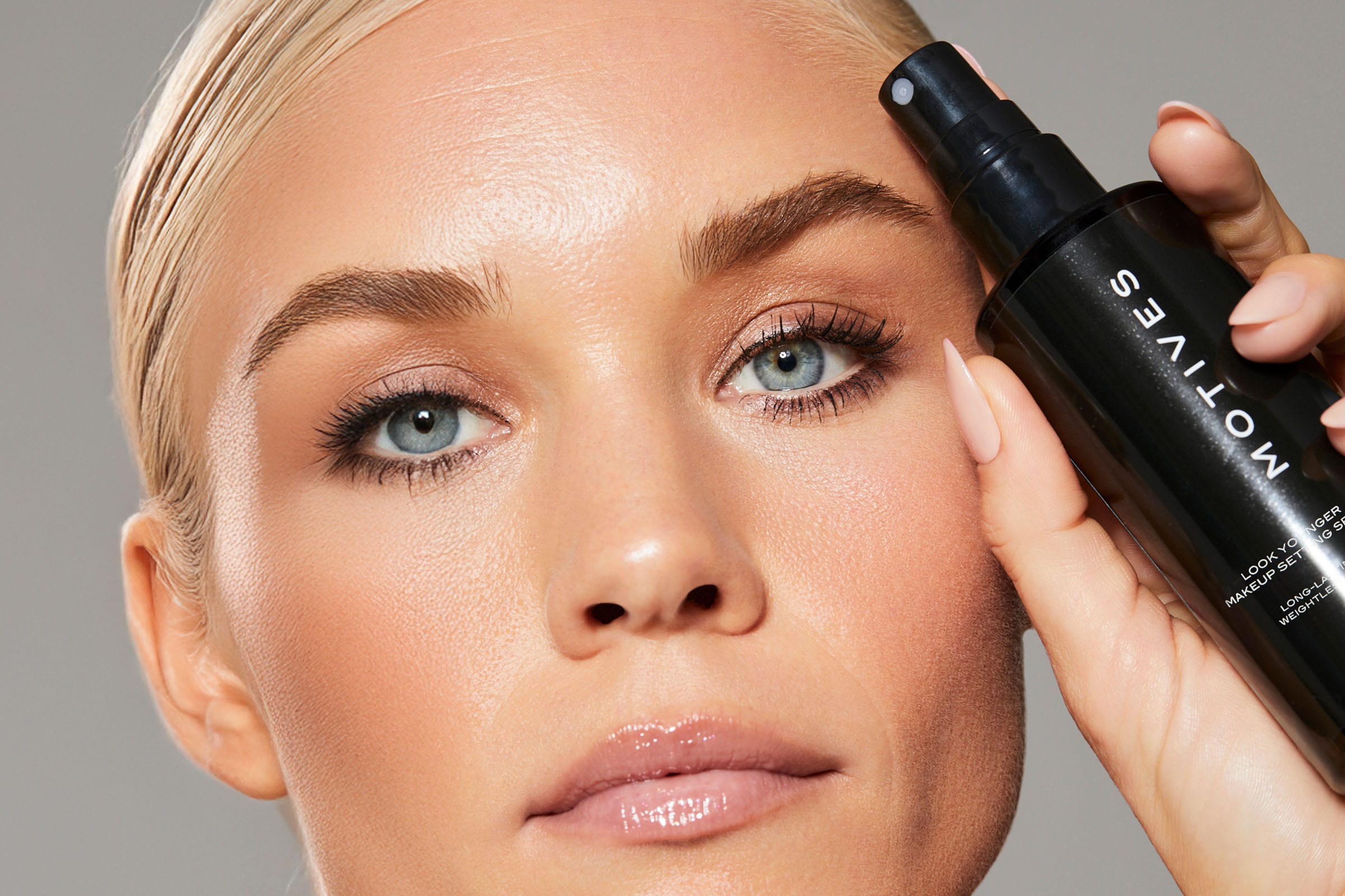 Women holding look younger setting spray