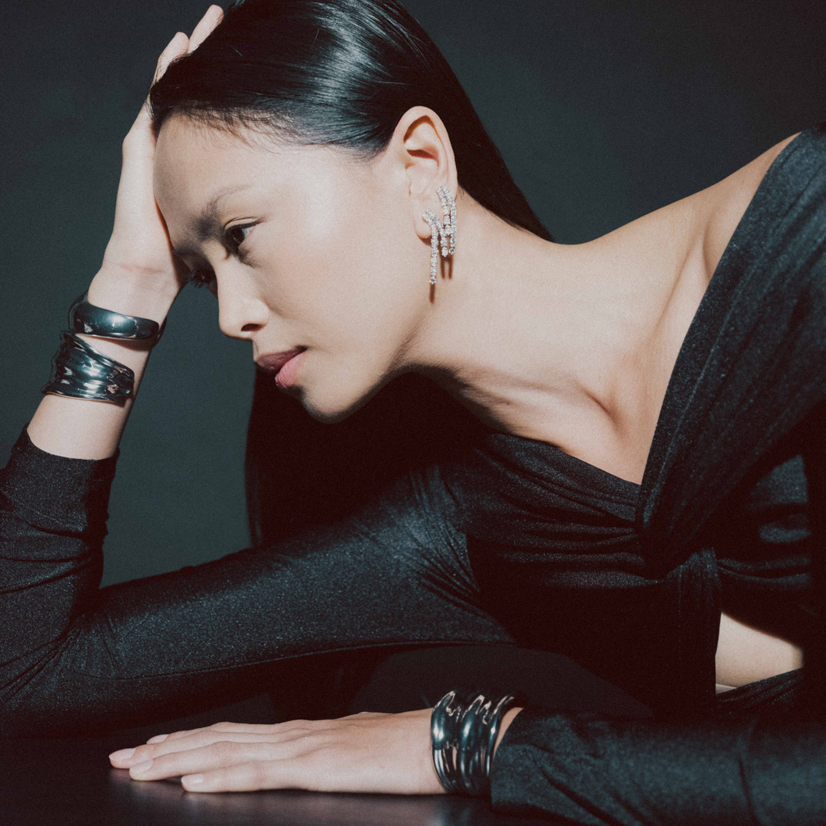 Model wearing layered jewelry