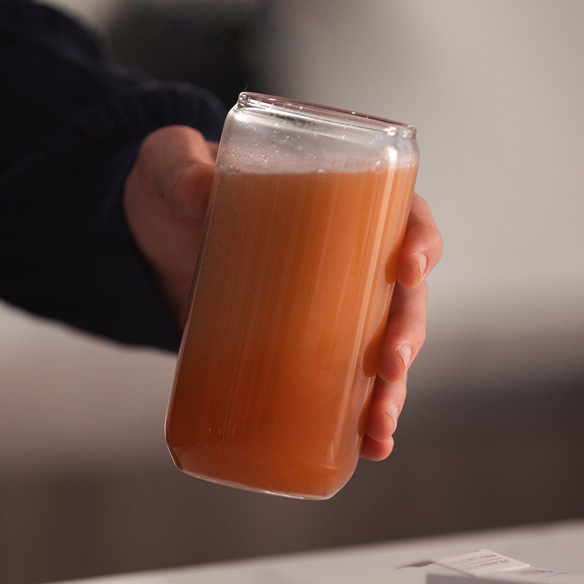 image of person lifting glass to drink