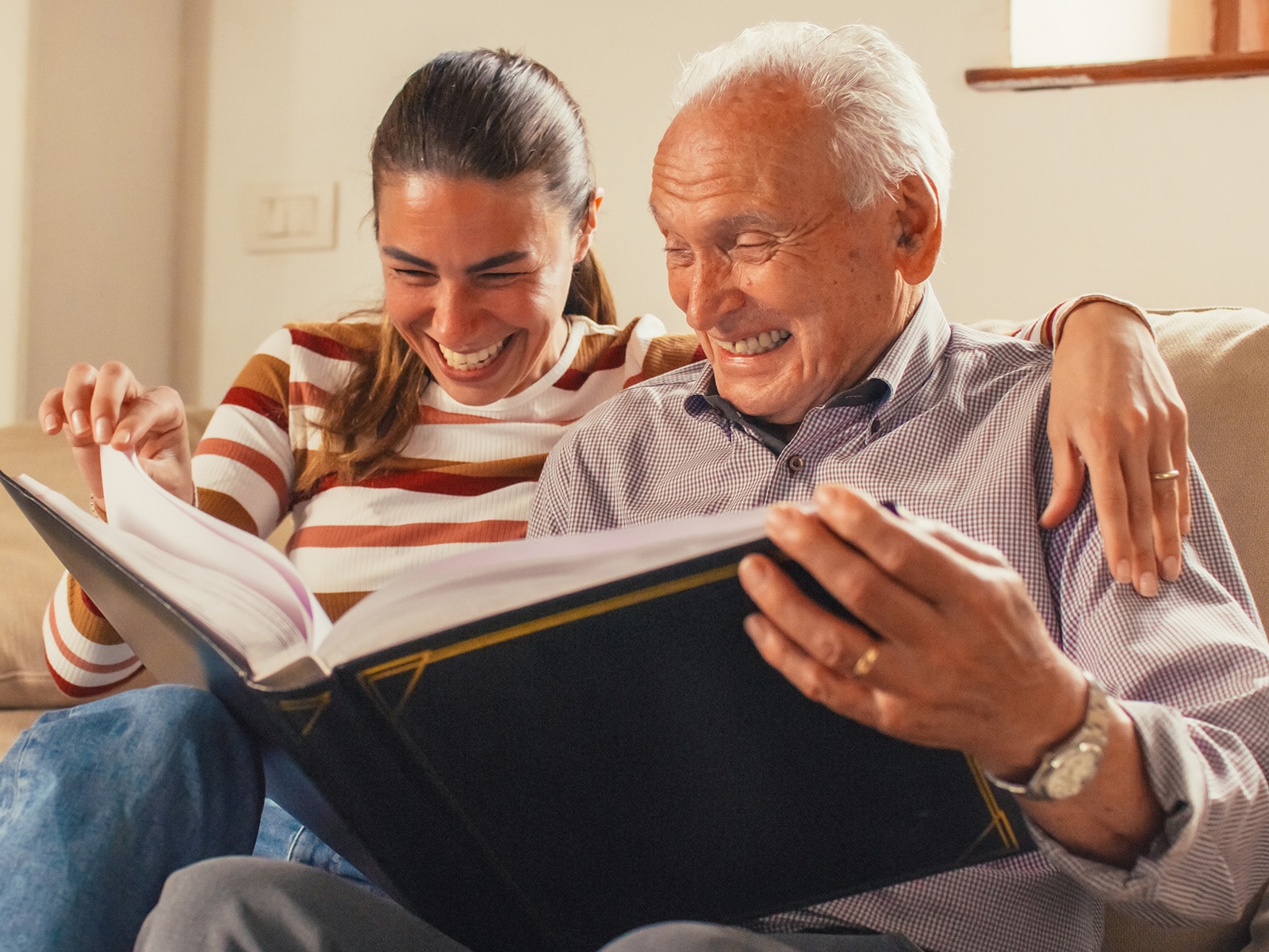 Image of two people reading a book together