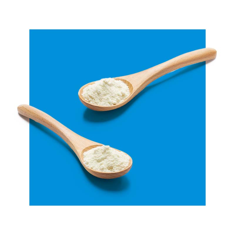 image of two wooden spoons containing milk powder