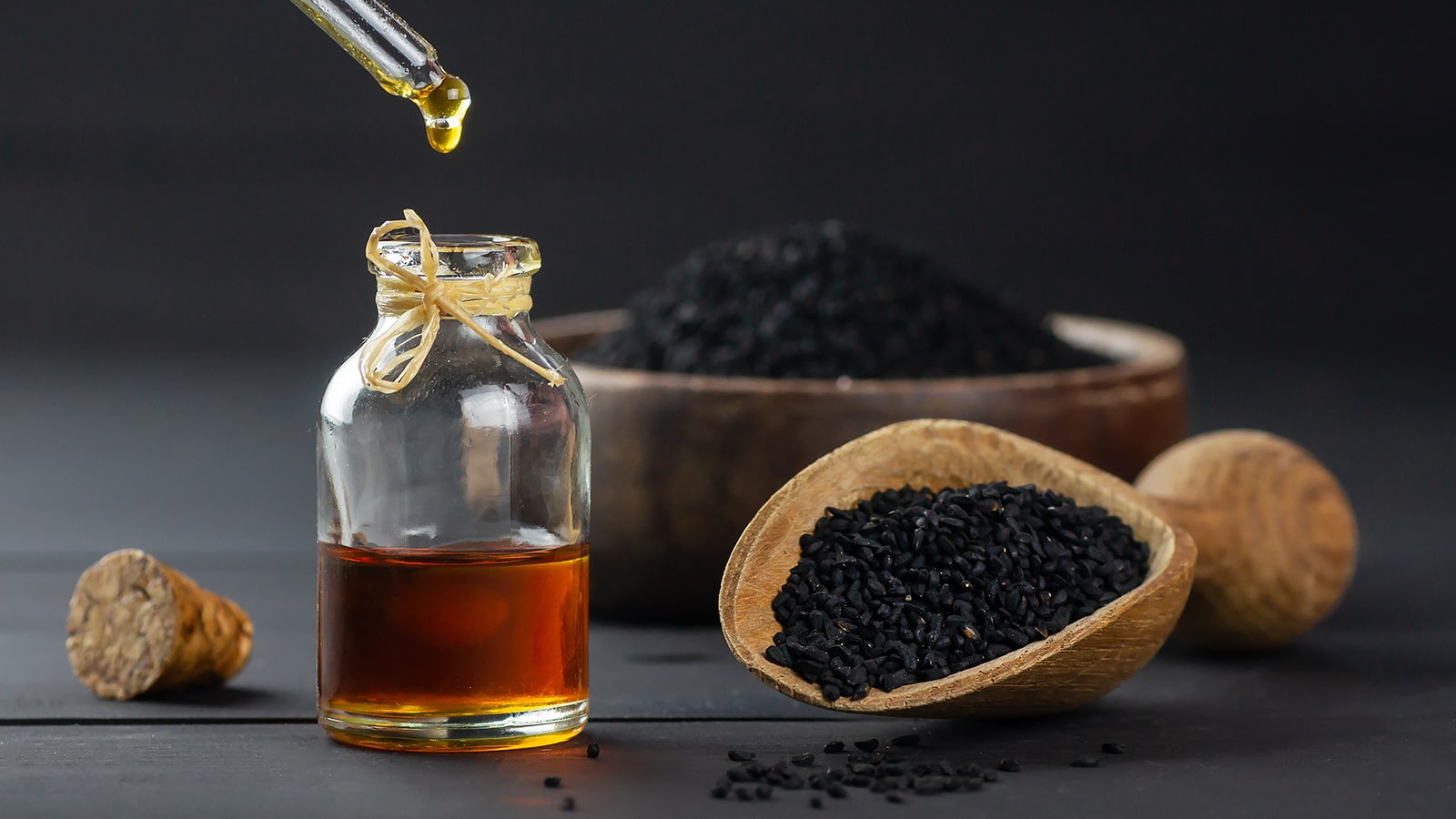 image of oil dropper and black cumin seed