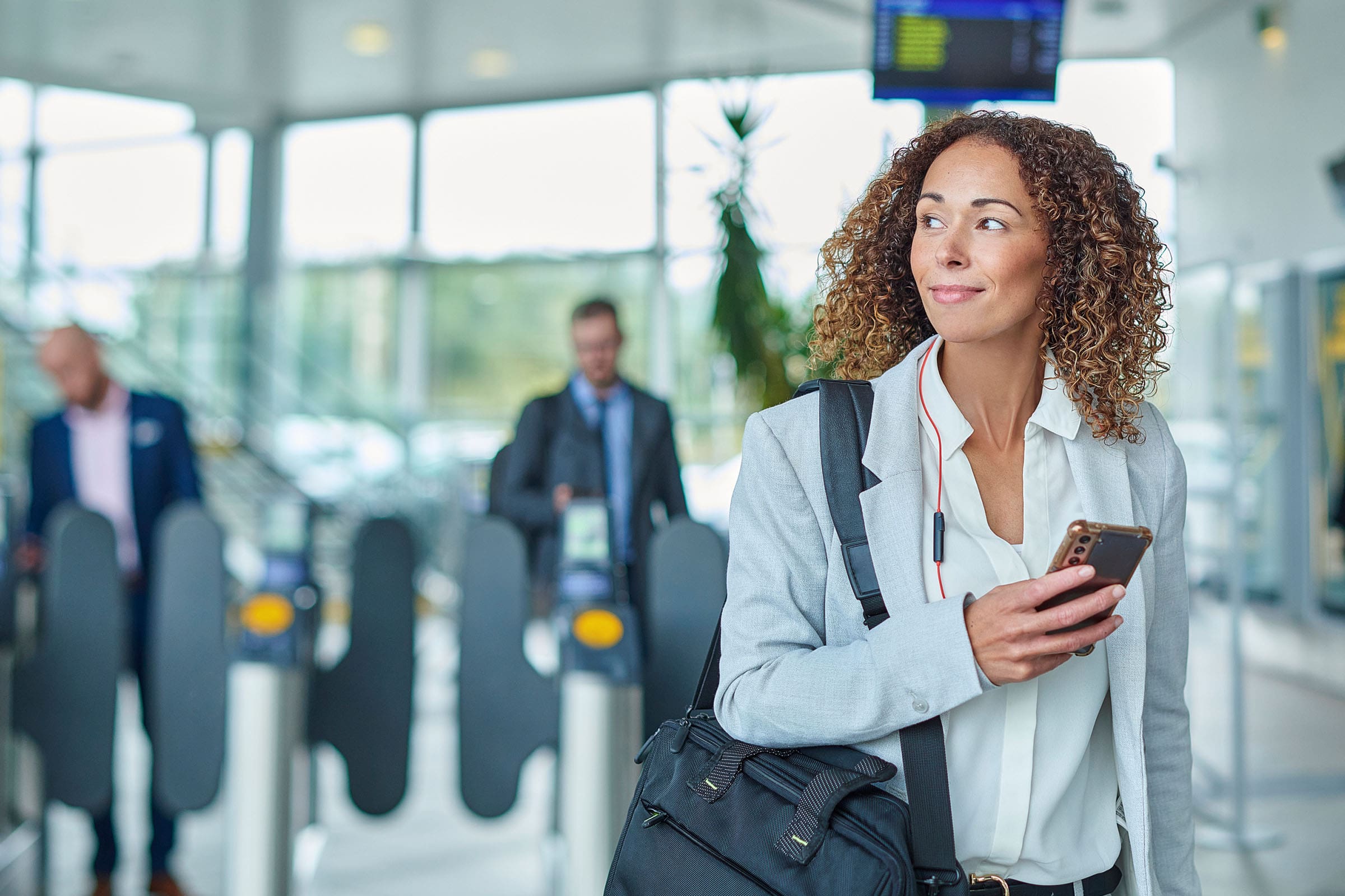 image of person walking with phone in hand