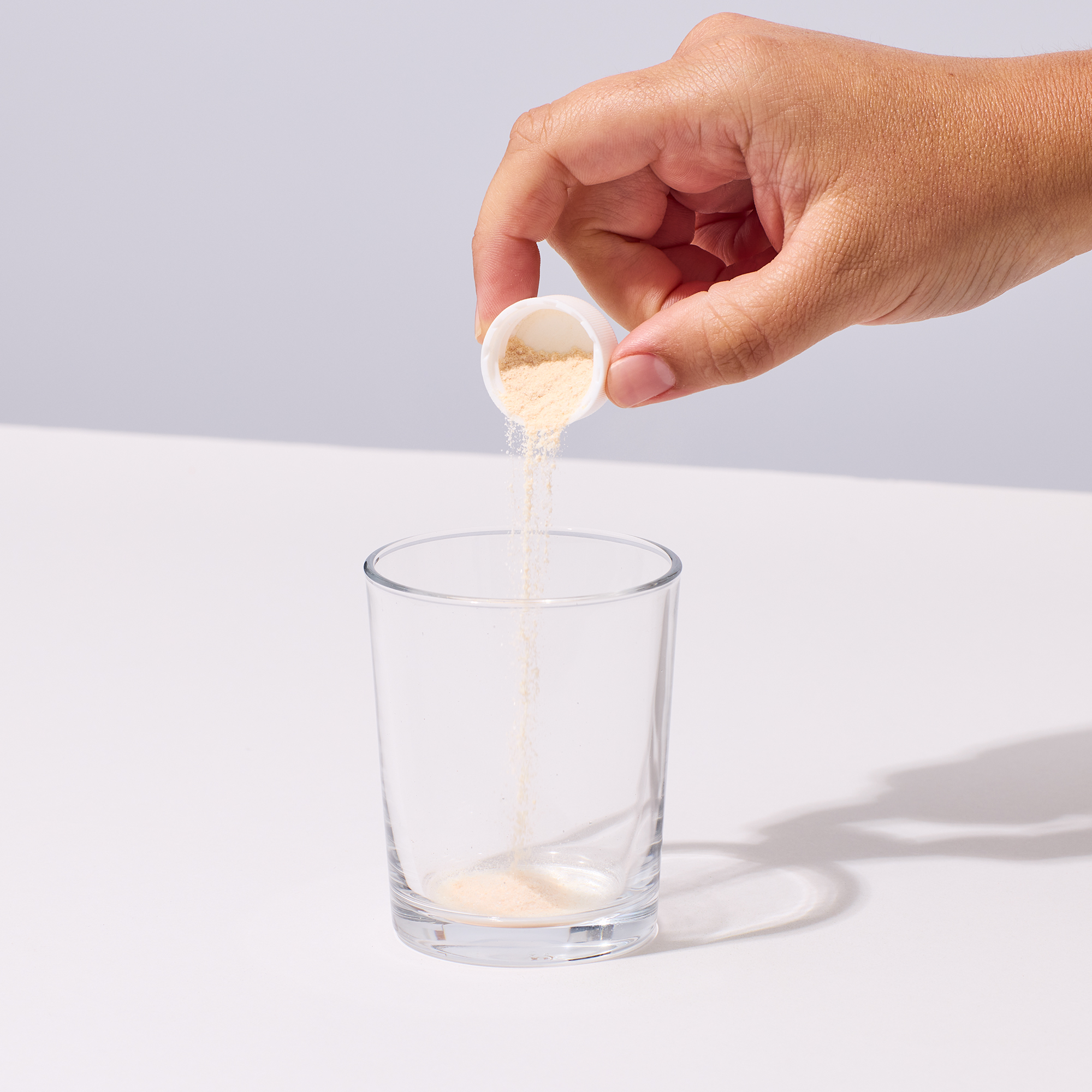 image of person pouring Prime Joint powder into a glass
