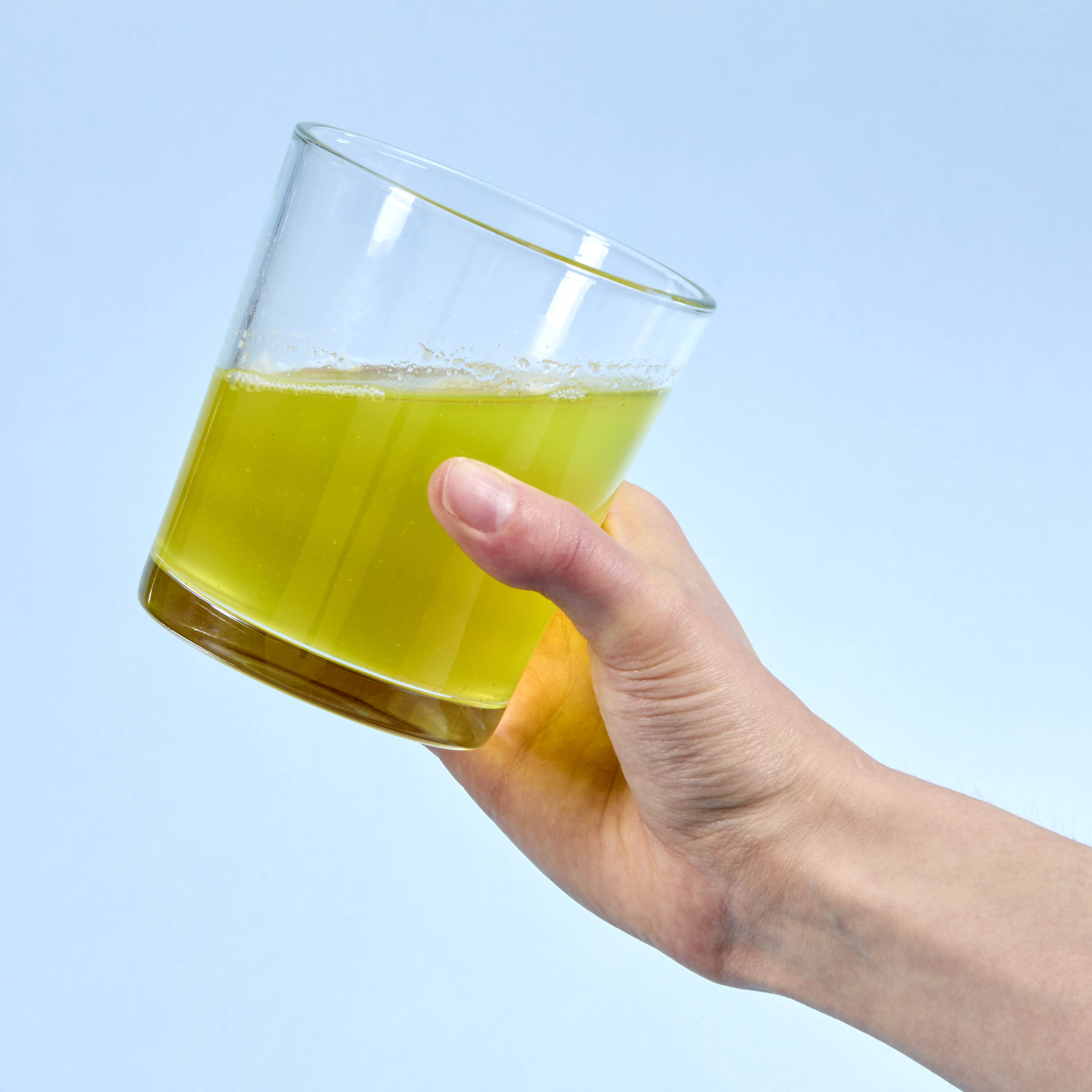 person picking up cup to drink
