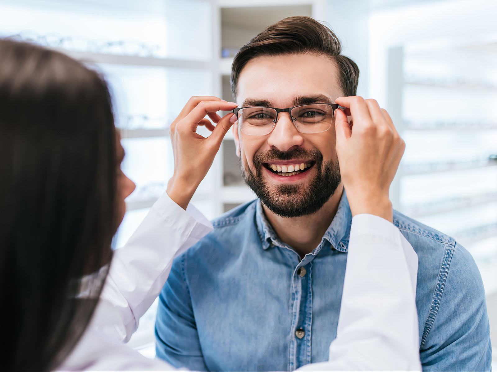image of woman putting glasses on a man