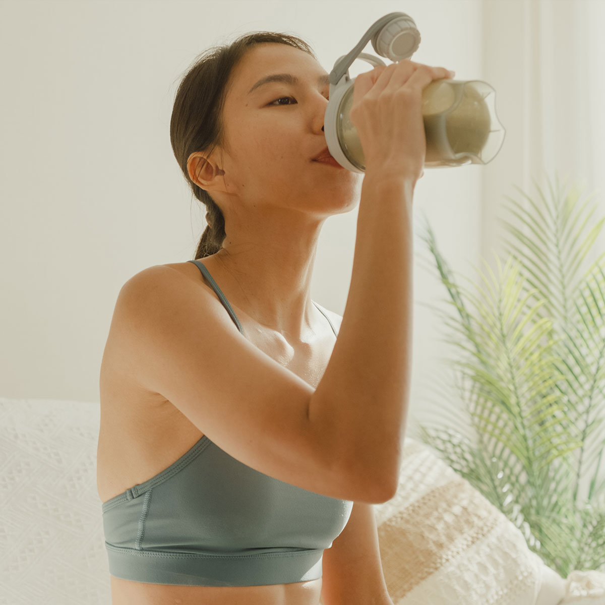 Girl drinking GoTrim Shake through a straw