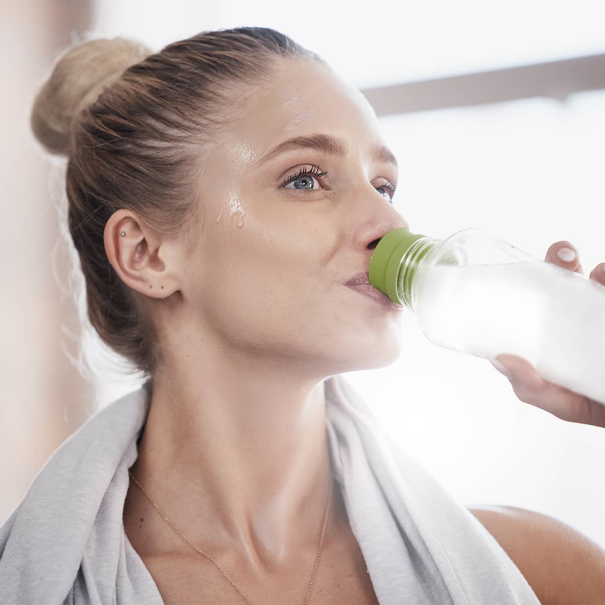 image of a person mixing Tower+ Electrolyte Mix in a cup