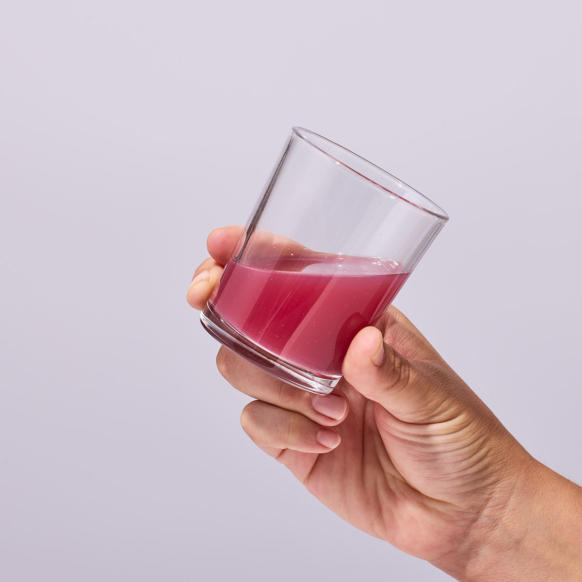 image of someone holding a glass containing a serving of Isotonix OPC-3 Beauty Blend