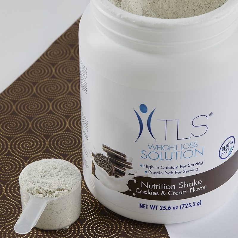 TLS Nutrition Shakes - Cookies & Cream container with scouper filled with product