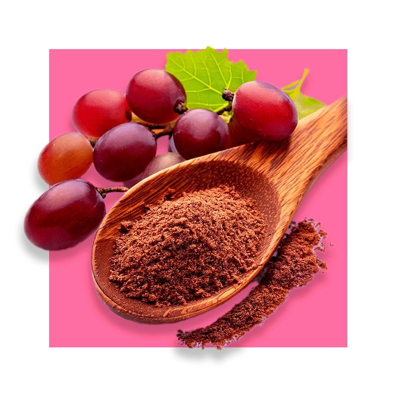 image of wooden spoon with grape seed extract and red grapes