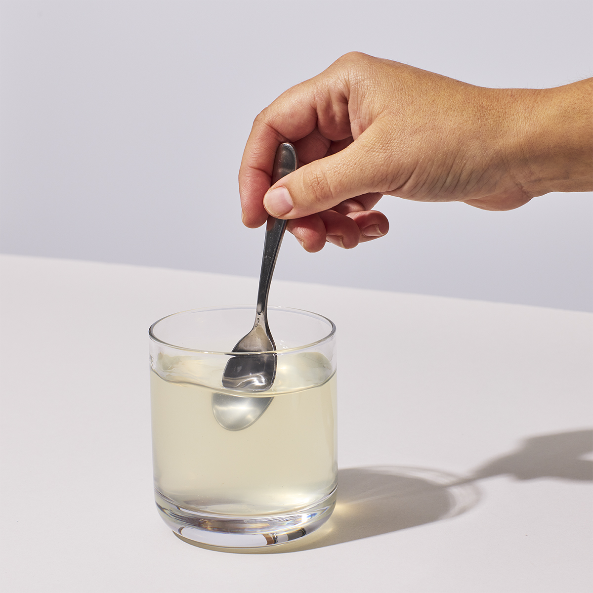 image of person mixing one serving of NutriClean Advanced Fiber Powder with water