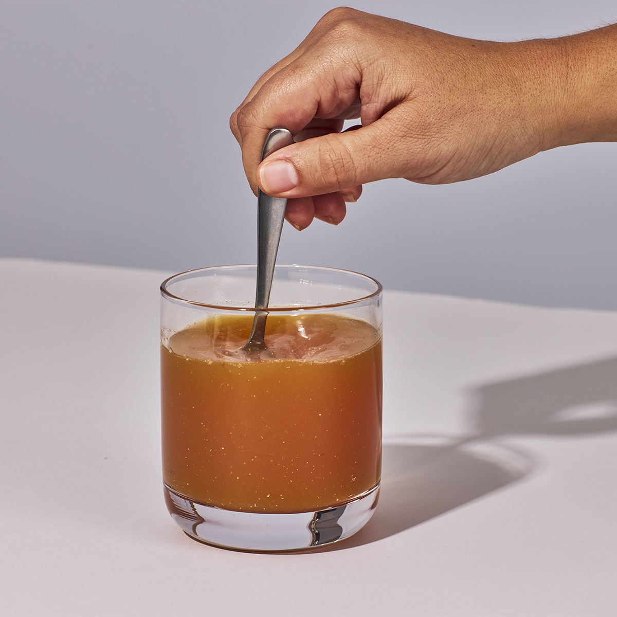 image of person stirring water and powder