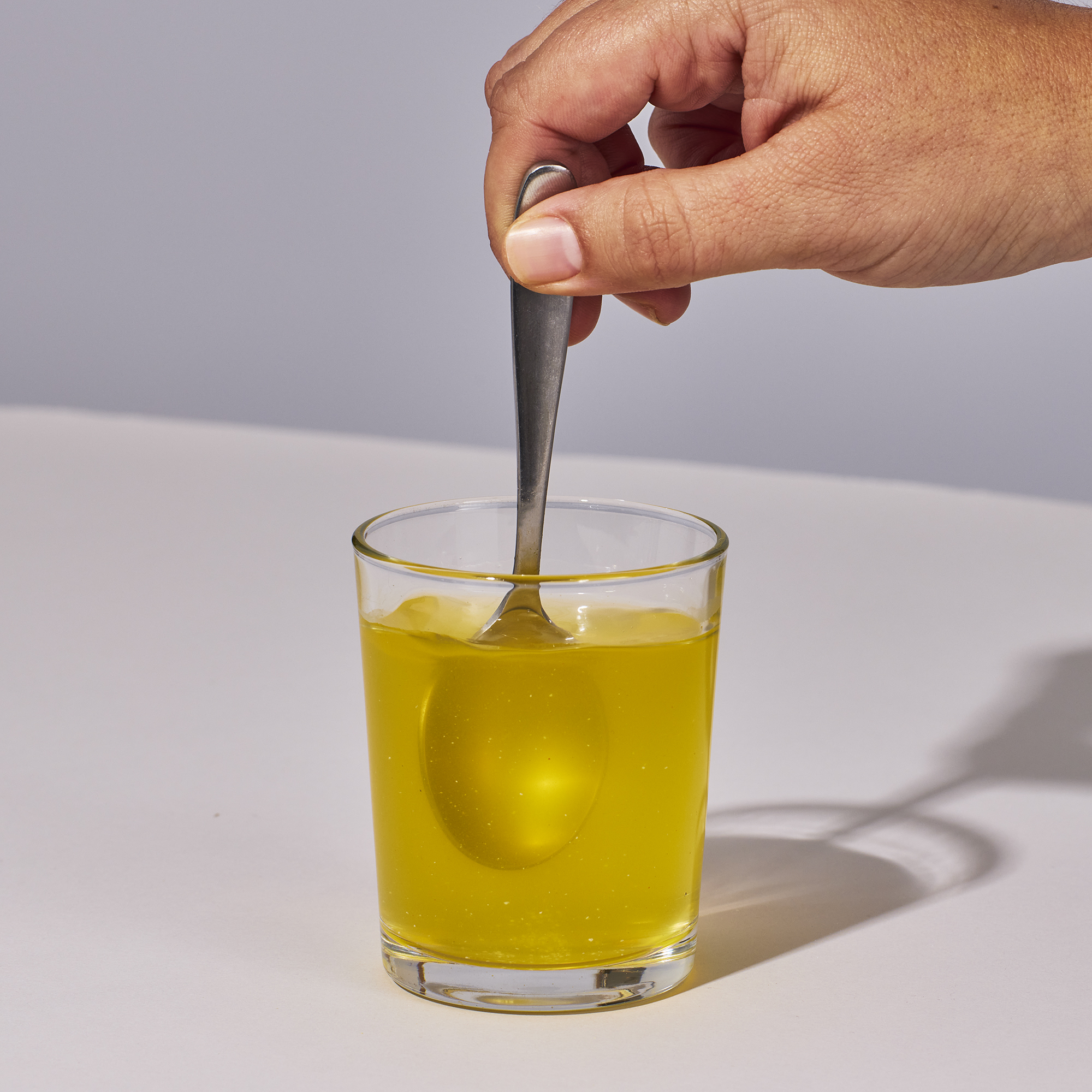 image of a hand mixing up a serving of Isotonix Multimineral with water