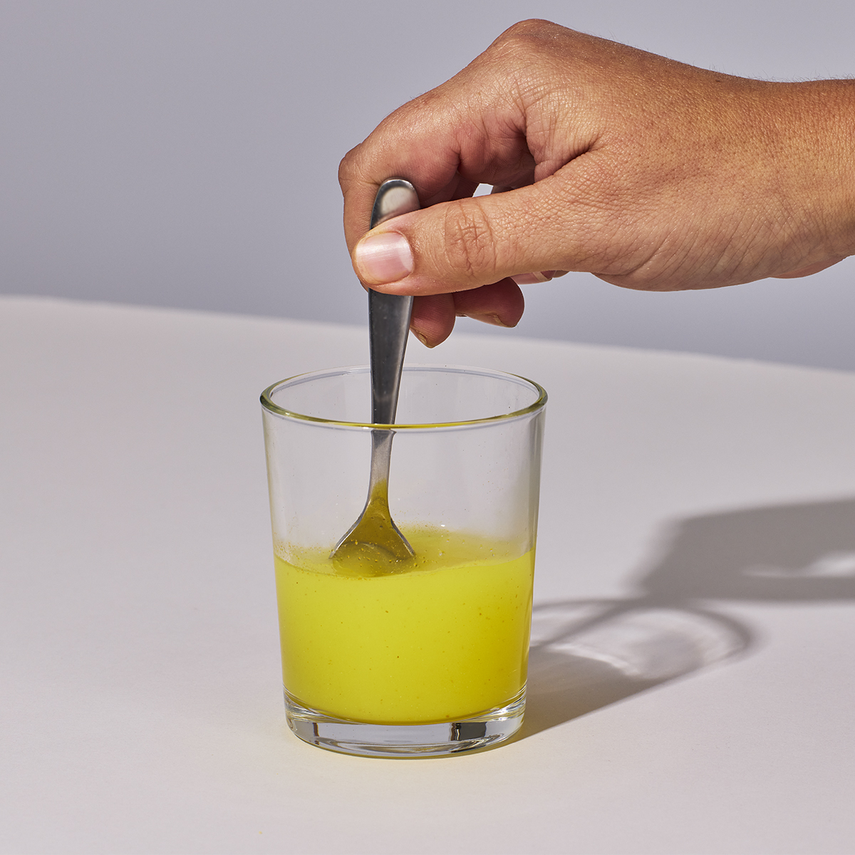 image of person stirring water and powder