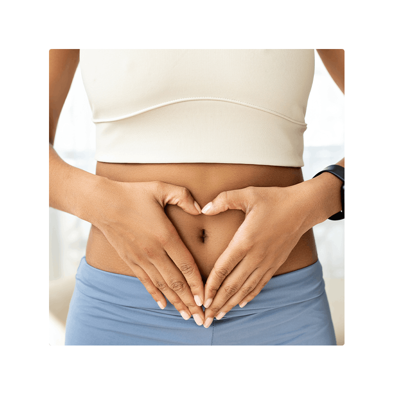image of woman with hands in shape of heart over belly