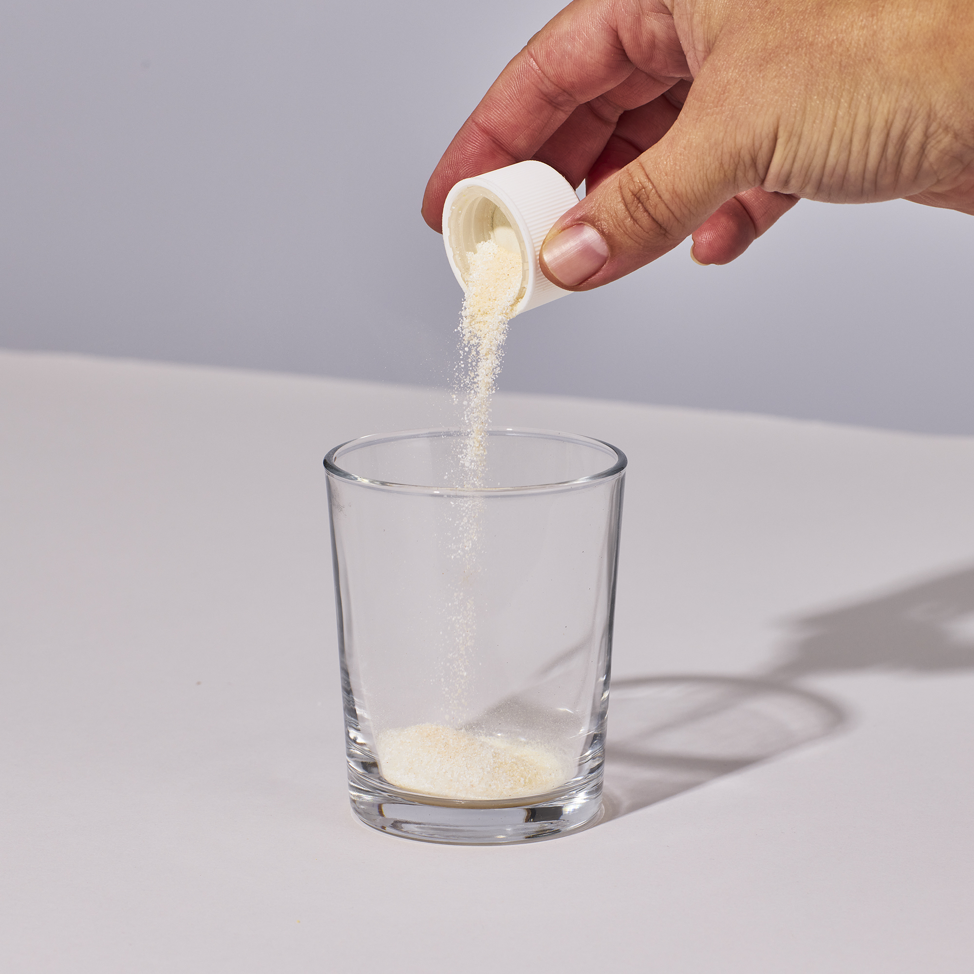 image of someone pouring one serving of Isotonix Multimineral powder into a glass