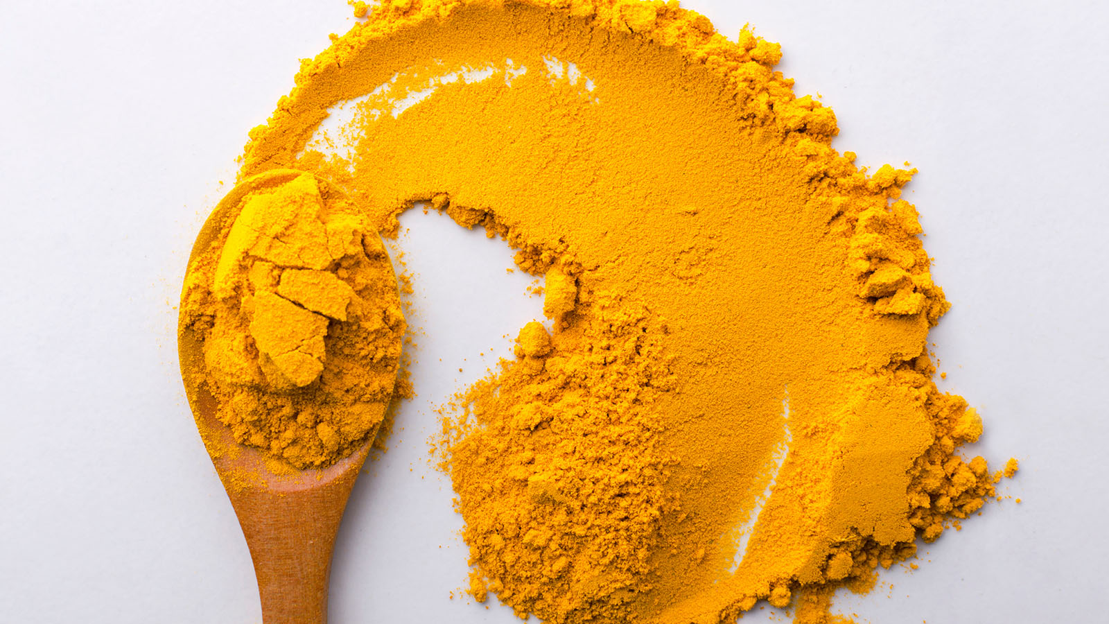 image of wooden spoon and turmeric powder